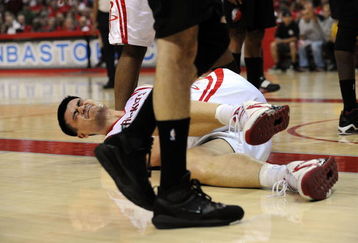 HOUSTON - APRIL 30:  Center Yao Ming #11 of the Houston Rockets falls after a foul by Greg Oden #52 of the Portland Trail Blazers in Game Six of the Western Conference Quarterfinals during the 2009 NBA Playoffs at Toyota Center on April 30, 2009 in Houston, Texas. NOTE TO USER: User expressly acknowledges and agrees that, by downloading and or using this photograph, User is consenting to the terms and conditions of the Getty Images License Agreement.  (Photo by Ronald Martinez/Getty Images)