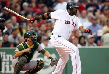 BOSTON - JULY 07:  David Ortiz #34 of the Boston Red Sox hits a single as Kurt Suzuki #8 of the Oakland Athletics defends on July 7, 2009 at Fenway Park in Boston, Massachusetts.  (Photo by Elsa/Getty Images)