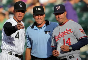 DENVER - JULY 06:  Manager Jim Tracy #4 of the Colorado Rockies reviews the ground rules with manager Manny Acta #14 of the Washington Nationals and homeplate umpire Angel Hernandez (C) prior to the game during MLB action at Coors Field on July 6, 2009 in Denver, Colorado.  (Photo by Doug Pensinger/Getty Images)