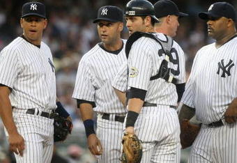 NEW YORK - JULY 2: (L-R) Alex Rodriguez #13, Derek Jeter #2, Francisco Cervelli #29, pitching coach Dave Eiland #58, CC Sabathia #55 and Robinson Cano #24 of the New York Yankees meet on the mound during action against the Seattle Mariners at Yankee Stadium on July 2, 2009 in the Bronx borough of New York City.  (Photo by Nick Laham/Getty Images)