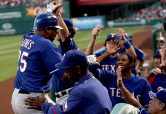 ANAHEIM, CA - JULY 8:  Andruw Jones #25 of the Texas Rangers is greeted by manager Ron Washington (C) and teammates as he returns to the dugout after hitting his second home run of the game against the Los Angeles Angels of Anaheim in the third inning at Angel Stadium July 8, 2009 in Anaheim, California.  (Photo by Stephen Dunn/Getty Images)