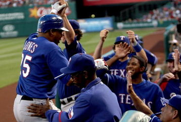 ANAHEIM, CA - JULY 8:  Andruw Jones #25 of the Texas Rangers is greeted by manager Ron Washington (C) and teammates as he returns to the dugout after hitting his second home run of the game against the Los Angeles Angels of Anaheim in the third inning at Angel Stadium July 8, 2009 in Anaheim, California.  (Photo by Stephen Dunn/Getty Images)