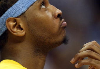 DENVER - MAY 29:  Carmelo Anthony #15 of the Denver Nuggets looks on from the bench in the fourth quarter of Game Six of the Western Conference Finals during the 2009 NBA Playoffs against the Los Angeles Lakers at Pepsi Center on May 29, 2009 in Denver, Colorado. NOTE TO USER: User expressly acknowledges and agrees that, by downloading and or using this photograph, User is consenting to the terms and conditions of the Getty Images License Agreement.  (Photo by Jed Jacobsohn/Getty Images)