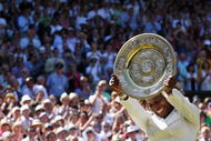 WIMBLEDON, ENGLAND - JULY 04:  Serena Williams of USA celebrates with the Championship trophy after the women's singles final match against Venus Williams of USA on Day Twelve of the Wimbledon Lawn Tennis Championships at the All England Lawn Tennis and Croquet Club on July 4, 2009 in London, England. Serena Williams of USA won 7-6, 6-2.  (Photo by Hamish Blair/Getty Images)