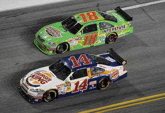 DAYTONA BEACH, FL - JULY 04: Tony Stewart, driver of the #14 Burger King Chevrolet, leads Kyle Busch, driver of the #18 Interstate Battereis Toyota, during the NASCAR Sprint Cup Series 51st Annual Coke Zero 400 at Daytona International Speedway on July 4, 2009 in Daytona Beach, Florida.  (Photo by John Harrelson/Getty Images for NASCAR)
