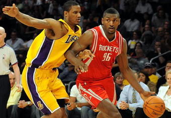LOS ANGELES, CA - MAY 06:  Ron Artest #96 of the Houston Rockets moves the ball against Trevor Ariza #3 of the Los Angeles Lakers in Game Two of the Western Conference Semifinals during the 2009 NBA Playoffs at Staples Center on May 6, 2009 in Los Angeles, California. NOTE TO USER: User expressly acknowledges and agrees that, by downloading and or using this photograph, User is consenting to the terms and conditions of the Getty Images License Agreement.  (Photo by Harry How/Getty Images)
