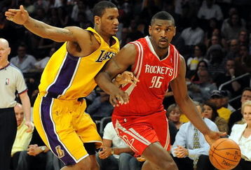 LOS ANGELES, CA - MAY 06:  Ron Artest #96 of the Houston Rockets moves the ball against Trevor Ariza #3 of the Los Angeles Lakers in Game Two of the Western Conference Semifinals during the 2009 NBA Playoffs at Staples Center on May 6, 2009 in Los Angeles, California. NOTE TO USER: User expressly acknowledges and agrees that, by downloading and or using this photograph, User is consenting to the terms and conditions of the Getty Images License Agreement.  (Photo by Harry How/Getty Images)