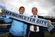 MANCHESTER, ENGLAND - JUNE 11:  Mark Hughes (R), manager of Manchester City unveils new signing Gareth Barry at a Press conference at the City of Manchester Stadium on June 11, 2009 in Manchester, England.  (Photo by Matthew Lewis/Getty Images)