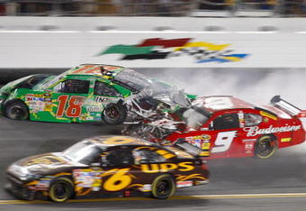 DAYTONA BEACH, FL - JULY 04:  Kasey Kahne, driver of the #9 Budweiser Dodge, crashes into the rear of Kyle Busch, driver of the #18 Interstate Batteries Toyota, after Kyle hit the wall on the final lap during the NASCAR Sprint Cup Series 51st Annual Coke Zero 400 at Daytona International Speedway on July 4, 2009 in Daytona Beach, Florida.  (Photo by Geoff Burke/Getty Images for NASCAR)