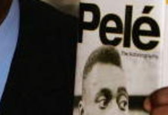 LONDON - MAY 18:  Brazilian football hero Pele holds copies of his autobiography at a book launch at the Virgin Megastore Picadilly on May 18, 2006 in London, England. The man they also call Edson Arantes do Nascimento attended the launch signing copies of his new book, Pele ? The Autobiography.  (Photo by Daniel Berehulak/Getty Images)