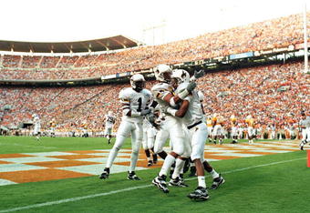 4 Sep 1999: Tommy Nash #19 of the Wyoming Cowboys celebrates his touchdown with teammates Wendell Montgomery #83 and Willie King #1 during a game against the Tennessee Volunteers at the Neyland Stadium in Knoxville, Tennessee. The Volunteers defeated the Cowboys 42-17.