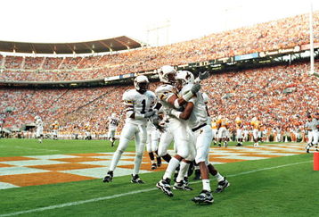 4 Sep 1999: Tommy Nash #19 of the Wyoming Cowboys celebrates his touchdown with teammates Wendell Montgomery #83 and Willie King #1 during a game against the Tennessee Volunteers at the Neyland Stadium in Knoxville, Tennessee. The Volunteers defeated the Cowboys 42-17.
