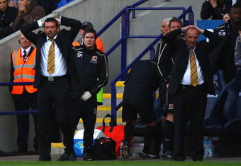 BOLTON, ENGLAND - MAY 16:  Phil Brown (L) Hull City manager and his assistant Brian Horton (R) react after a near miss during the Barclay's Premier League match between Bolton Wanderers and Hull City at the Reebok Stadium on May 16, 2009 in Bolton, England.  (Photo by Michael Steele/Getty Images)