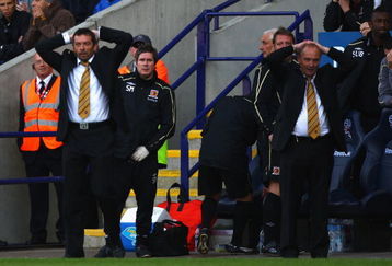 BOLTON, ENGLAND - MAY 16:  Phil Brown (L) Hull City manager and his assistant Brian Horton (R) react after a near miss during the Barclay's Premier League match between Bolton Wanderers and Hull City at the Reebok Stadium on May 16, 2009 in Bolton, England.  (Photo by Michael Steele/Getty Images)