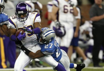DETROIT - DECEMBER 10:  Travis Taylor #89 of the Minnesota Vikings is tackled by Daniel Bullocks #27 of the Detroit Lions on December 10, 2006 at Ford Field in Detroit, Michigan. The Vikings defeated the Lions 30-20.  (Photo by Gregory Shamus/Getty Images)