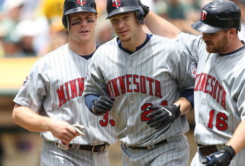 OAKLAND, CA - JUNE 11:  Joe Crede #24 of the Minnesota Twins is congratulated by Jason Kubel #16 and Justin Morneau #33 after hitting a home run in the fourth inning against the Oakland Athletics during a Major League Baseball game on June 11, 2009 at the Oakland Coliseum in Oakland, California.  (Photo by Jed Jacobsohn/Getty Images)