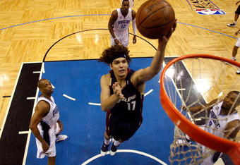 ORLANDO, FL - MAY 30:  Anderson Varejao #17 of the Cleveland Cavaliers drives to the hoop against Rafer Alston #1 and Rashard Lewis #9 of the Orlando Magic in Game Six of the Eastern Conference Finals during the 2009 Playoffs at Amway Arena on May 30, 2009 in Orlando, Florida. NOTE TO USER: User expressly acknowledges and agrees that, by downloading and or using this photograph, User is consenting to the terms and conditions of the Getty Images License Agreement  (Photo by Scott Audette-Pool/Getty Images)