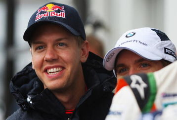 NURBURG, GERMANY - JULY 09:  Sebastian Vettel (L) of Germany and Red Bull Racing shares a joke with other German drivers in the paddock during previews to the German Formula One Grand Prix at Nurburgring on July 9, 2009 in Nurburg, Germany.  (Photo by Mark Thompson/Getty Images)