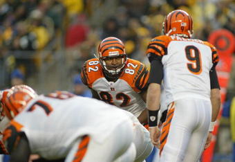 PITTSBURGH - DECEMBER 4:  Tight end Reggie Kelly #82 of the Cincinnati Bengals listens to quarterback Carson Palmer #9 against the Pittsburgh Steelers at Heinz Field on December 4, 2005 in Pittsburgh, Pennsylvania. The Bengals defeated the Steelers 38-31. (Photo by Rick Stewart/Getty Images)