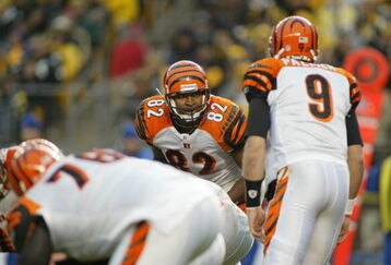 PITTSBURGH - DECEMBER 4:  Tight end Reggie Kelly #82 of the Cincinnati Bengals listens to quarterback Carson Palmer #9 against the Pittsburgh Steelers at Heinz Field on December 4, 2005 in Pittsburgh, Pennsylvania. The Bengals defeated the Steelers 38-31. (Photo by Rick Stewart/Getty Images)