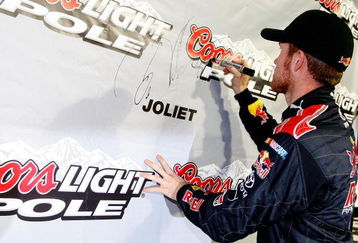 JOLIET, IL - JULY 09:  Brian Vickers, driver of the #83 Red Bull Toyota, signs the wall in victory lane after qualifying for the pole position in the NASCAR Sprint Cup Series LifeLock.com 400 at Chicagoland Speedway on July 9, 2009 in Joliet, Illinois.  (Photo by Jason Smith/Getty Images for NASCAR)
