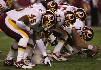 LANDOVER, MD - SEPTEMBER 27:  The Washington Redskins offensive line sets for the snap of the ball during the fourth quarter of their game against the Dallas Cowboys in the third week of the NFL season at FedEx Field September 27, 2004 in Landover, Maryland.  (Photo by Doug Pensinger/Getty Images)