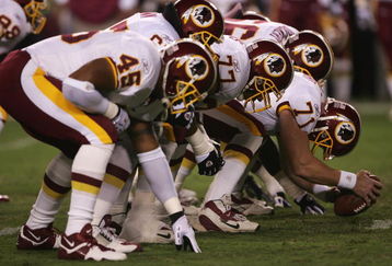 LANDOVER, MD - SEPTEMBER 27:  The Washington Redskins offensive line sets for the snap of the ball during the fourth quarter of their game against the Dallas Cowboys in the third week of the NFL season at FedEx Field September 27, 2004 in Landover, Maryland.  (Photo by Doug Pensinger/Getty Images)