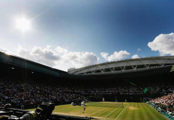 WIMBLEDON, ENGLAND - JULY 05:  A general view of Centre Court as Roger Federer of Switzerland serves during the men's singles final match against Andy Roddick of USA on Day Thirteen of the Wimbledon Lawn Tennis Championships at the All England Lawn Tennis and Croquet Club on July 5, 2009 in London, England.  (Photo by Paul Gilham/Getty Images)