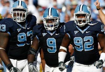 CHAPEL HILL, NC - NOVEMBER 08:  Cam Thomas #93, Marvin Austin #9 and E.J. Wilson #92 of the North Carolina Tar Heels celebrate after a defensive stop against the Georgia Tech Yellow Jackets during the game at Kenan Stadium on November 8, 2008 in Chapel Hill, North Carolina.  (Photo by Kevin C. Cox/Getty Images)