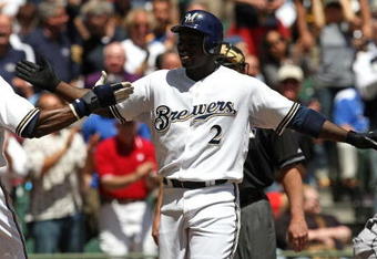 MILWAUKEE - MAY 14: Bill Hall #2 of the Milwaukee Brewers is congratulated by teammate Mike Cameron #25 after hitting his 100th career home run in the 2nd inning against the Florida Marlins on May 14, 2009 at Miller Park in Milwaukee, Wisconsin. The Brewers defeated the Marlins 5-3. (Photo by Jonathan Daniel/Getty Images)