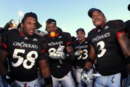 CINCINNATI, OH - NOVEMBER 29: Brandon Mills #58, Lynell Payne #82 and Delbert Ferguson #3 of the Cincinnati Bearcats celebrate with teammates after the game against the Syracuse Orange at Nippert Stadium on November 29, 2008 in Cincinnati, Ohio. The Bearcats defeated the Orange 30-10 to claim the Big East title and a spot in the Orange Bowl. (Photo by Joe Robbins/Getty Images)