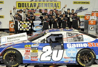 JOLIET, IL - JULY 10:  Joey Logano, driver of the #20 GameStop/Wii Sports Resorts Toyota, poses with his crew in victory lane after winning the NASCAR Nationwide Series Dollar General 300 at Chicagoland Speedway on July 10, 2009 in Joliet, Illinois.  (Photo by John Harrelson/Getty Images)