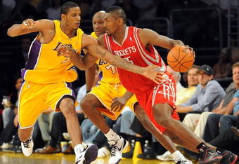 LOS ANGELES, CA - MAY 06:  Ron Artest #96 of the Houston Rockets moves the ball as Trevor Ariza #3 of the Los Angeles Lakers goes for the steal alongside teammate Lamar Odom #7 in Game Two of the Western Conference Semifinals during the 2009 NBA Playoffs at Staples Center on May 6, 2009 in Los Angeles, California. NOTE TO USER: User expressly acknowledges and agrees that, by downloading and or using this photograph, User is consenting to the terms and conditions of the Getty Images License Agreement.  (Photo by Harry How/Getty Images)