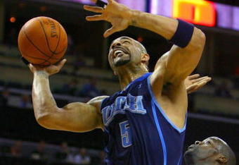 CHARLOTTE, NC - NOVEMBER 14:  Carlos Boozer #5 of the Utah Jazz is fouled by Emeka Okafor #50 of the Charlotte Bobcats during their game at Time Warner Cable Arena on November 14, 2008 in Charlotte, North Carolina. NOTE TO USER: User expressly acknowledges and agrees that, by downloading and/or using this Photograph, user is consenting to the terms and conditions of the Getty Images License Agreement. (Photo by Streeter Lecka/Getty Images)