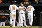 BALTIMORE - APRIL 06:  Adam Jones #10 and Nick Markakis #21 of the Baltimore Orioles are congratulated by Luke Scott #30 after scoring in the eighth inning against the New York Yankees during opening day on April 6, 2009 at Camden Yards in Baltimore, Maryland.  (Photo by Greg Fiume/Getty Images)