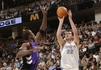 DENVER - NOVEMBER 17:  Nikoloz Tskitishvili #22 of the Denver Nuggets shoots over Jerome Moiso #6 of the Toronto Raptors during the game at Pepsi Center on November 17, 2004 in Denver, Colorado.  The Nuggets won 112-106.   NOTE TO USER: User expressly acknowledges and agrees that, by downloading and/or using this Photograph, user is consenting to the terms and conditions of the Getty Images License Agreement. (Photo by Brian Bahr/Getty Images)
