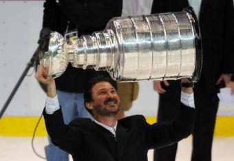 DETROIT - JUNE 12:  Co-Ownter and Chairman Mario Lemieux of the Pittsburgh Penguins hoists the Stanley Cup overhead after Game Seven of the 2009 NHL Stanley Cup Finals against the Detroit Red Wings at Joe Louis Arena on June 12, 2009 in Detroit, Michigan. The Penguins defeated the Red Wings 2-1 in the seventh game to win the Stanley Cup Finals series 4 games to 3. (Photo by Harry How/Getty Images)