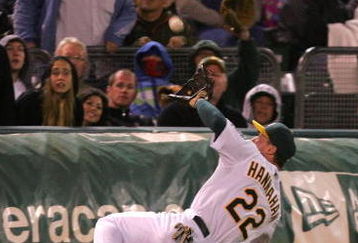 OAKLAND, CA - MAY 23:  Jack Hannahan #22 of the Oakland Athletics makes a diving catch on a ball hit by Miguel Montero #26 of the Arizona Diamondbacks in the eighth inning of their game at the Oakland Coliseum on May 23, 2009 in Oakland, California.  (Photo by Ezra Shaw/Getty Images)