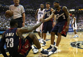 ORLANDO, FL - MAY 30: Mo Williams #2 of the Cleveland Cavaliers helps up teammate LeBron James after a foul in the first quarter against  the Orlando Magic in Game Six of the Eastern Conference Finals during the 2009 Playoffs at Amway Arena on May 30, 2009 in Orlando, Florida. NOTE TO USER: User expressly acknowledges and agrees that, by downloading and or using this photograph, User is consenting to the terms and conditions of the Getty Images License Agreement  (Photo by Elsa/Getty Images)