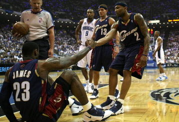 ORLANDO, FL - MAY 30: Mo Williams #2 of the Cleveland Cavaliers helps up teammate LeBron James after a foul in the first quarter against  the Orlando Magic in Game Six of the Eastern Conference Finals during the 2009 Playoffs at Amway Arena on May 30, 2009 in Orlando, Florida. NOTE TO USER: User expressly acknowledges and agrees that, by downloading and or using this photograph, User is consenting to the terms and conditions of the Getty Images License Agreement  (Photo by Elsa/Getty Images)
