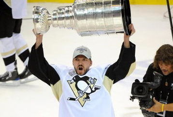 DETROIT - JUNE 12:  Philippe Boucher #43 of the Pittsburgh Penguins hoists the Stanley Cup overhead after Game Seven of the 2009 NHL Stanley Cup Finals against the Detroit Red Wings at Joe Louis Arena on June 12, 2009 in Detroit, Michigan. The Penguins defeated the Red Wings 2-1 in the seventh game to win the Stanley Cup Finals series 4 games to 3. (Photo by Harry How/Getty Images)