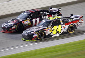 JOLIET, IL - JULY 11: Jeff Gordon, driver of the #24 National Guard Patriot Academy/DuPont Chevrolet, races Denny Hamlin, driver of the #11 FedEx Freight Toyota, during the NASCAR Sprint Cup Series LifeLock.com 400 at Chicagoland Speedway on July 11, 2009 in Joliet, Illinois.  (Photo by Geoff Burke/Getty Images for NASCAR)