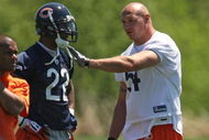 LAKE FOREST, IL - MAY 20: Brian Urlacher #54 of the Chicago Bears talks with teammate Matt Forte #22 during an organized team activity (OTA) practice on May 20, 2009 at Halas Hall in Lake Forest, Illinois.  (Photo by Jonathan Daniel/Getty Images)