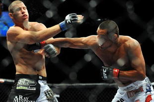 LAS VEGAS - JULY 11:  (R-L) Dan Henderson connects with a right to Mike Bisping during their middleweight bout during UFC 100 on July 11, 2009 in Las Vegas, Nevada.  (Photo by Jon Kopaloff/Getty Images)