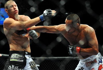 LAS VEGAS - JULY 11:  (R-L) Dan Henderson connects with a right to Mike Bisping during their middleweight bout during UFC 100 on July 11, 2009 in Las Vegas, Nevada.  (Photo by Jon Kopaloff/Getty Images)