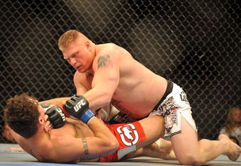 LAS VEGAS - JULY 11:  Brock Lesnar holds down Frank Mir  during their heavyweight title bout during UFC 100 on July 11, 2009 in  Las Vegas, Nevada. Lesnar defeated Mir by a second round knockout.   (Photo by Jon Kopaloff/Getty Images)
