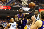 ORLANDO, FL - JUNE 14:  Lamar Odom #7 of the Los Angeles Lakers goes up for a shot between Rashard Lewis #9 and Dwight Howard #12 of the Orlando Magic in the second quarter of Game Five of the 2009 NBA Finals on June 14, 2009 at Amway Arena in Orlando, Florida.  NOTE TO USER:  User expressly acknowledges and agrees that, by downloading and or using this photograph, User is consenting to the terms and conditions of the Getty Images License Agreement.  (Photo by Ronald Martinez/Getty Images)