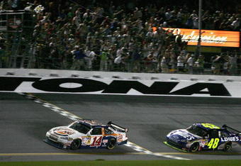 DAYTONA BEACH, FL - JULY 04: Tony Stewart, driver of the #14 Burger King Chevrolet, crosses the finish line ahead of Jimmie Johnson, drive of the #48 Lowe's Kobalt Tools Chevrolet, to win the NASCAR Sprint Cup Series 51st Annual Coke Zero 400 at Daytona International Speedway on July 4, 2009 in Daytona Beach, Florida.  (Photo by Jerry Markland/Getty Images for NASCAR)