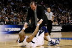 BOSTON - MARCH 28:  Jermaine Dixon #3 of the Pittsburgh Panthers is helped off the floor by an assistant coach during their game against the Villanova Wildcats during the NCAA Men's Basketball Tournament East Regionals at TD Banknorth Garden on March 28, 2009 in Boston, Massachusetts.  (Photo by Elsa/Getty Images)