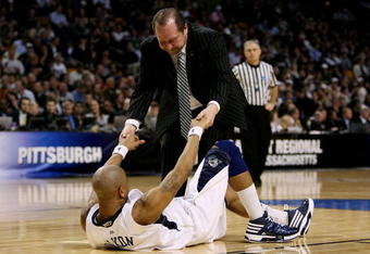 BOSTON - MARCH 28:  Jermaine Dixon #3 of the Pittsburgh Panthers is helped off the floor by an assistant coach during their game against the Villanova Wildcats during the NCAA Men's Basketball Tournament East Regionals at TD Banknorth Garden on March 28, 2009 in Boston, Massachusetts.  (Photo by Elsa/Getty Images)